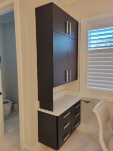 A bathroom with a sink and cabinets in it