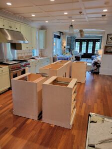 A kitchen with two large cabinets and a wooden floor