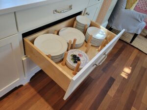 A drawer with many dishes in it
