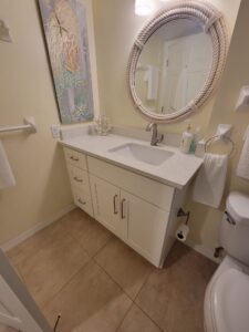 A bathroom with a sink, mirror and toilet.