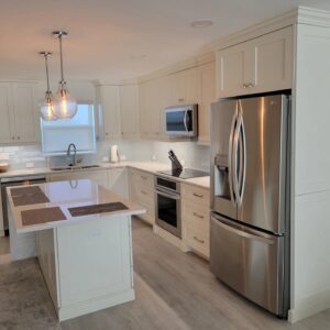 A kitchen with white cabinets and stainless steel appliances.