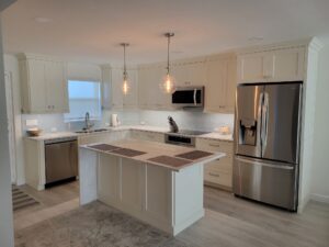 A kitchen with white cabinets and stainless steel appliances.