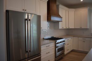 A kitchen with white cabinets and stainless steel appliances.