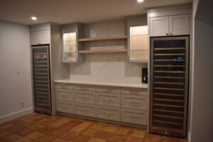 A kitchen with two refrigerators and a counter.