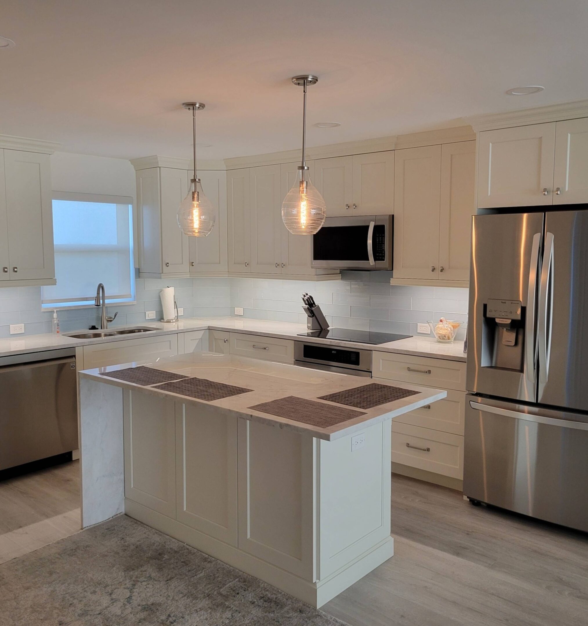 A kitchen with white cabinets and stainless steel appliances.